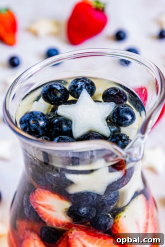 Freedom Sangria 8 A close-up shot capturing the vibrant colors and fresh fruit inside a glass of patriotic sangria, ready for summer enjoyment.