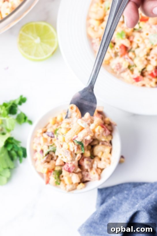 Elote Pasta Salad 10 Overhead shot of Mexican Street Corn Pasta Salad is light and healthy, yet so delicious. It’s the perfect side or main dish for a big gathering or just a quick dinner during the week with a Mexican twist!