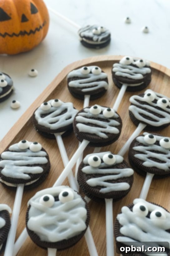 Halloween Mummy Oreo Pops 16 A close-up of a Mummy Oreo Pop, highlighting the texture of the icing and the adorable candy eyes