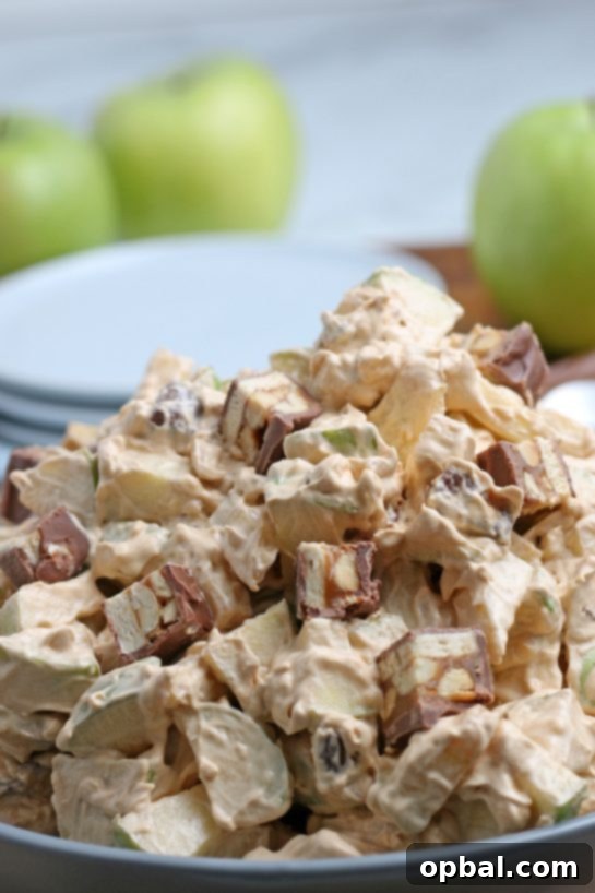 Caramel Apple Snickers Delight 11 Another close-up of the Caramel Apple Snickers Salad, emphasizing its appealing textures and colors, ready to be enjoyed as a perfect fall holiday or potluck treat.