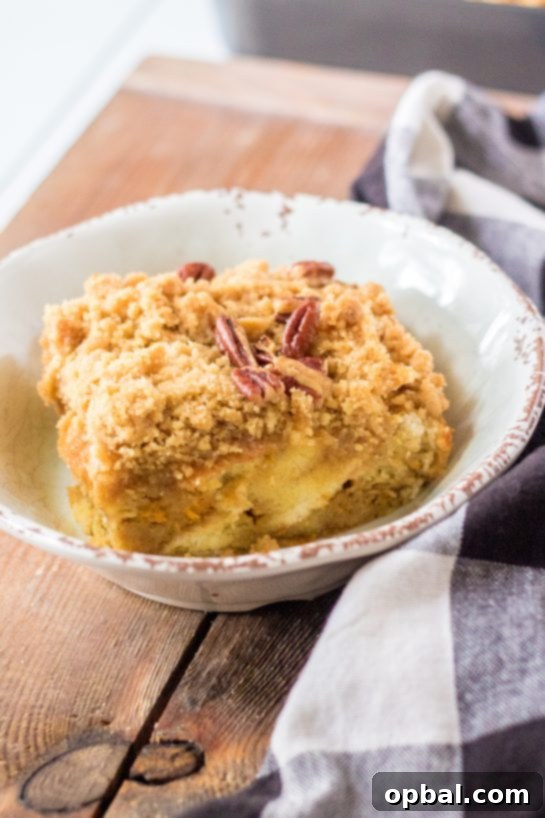 Spiced Sweet Potato French Toast Bake 12 A perfectly plated slice of Sweet Potato French Toast Casserole, dusted with powdered sugar, capturing the cozy essence of a Thanksgiving breakfast or a delightful holiday brunch.