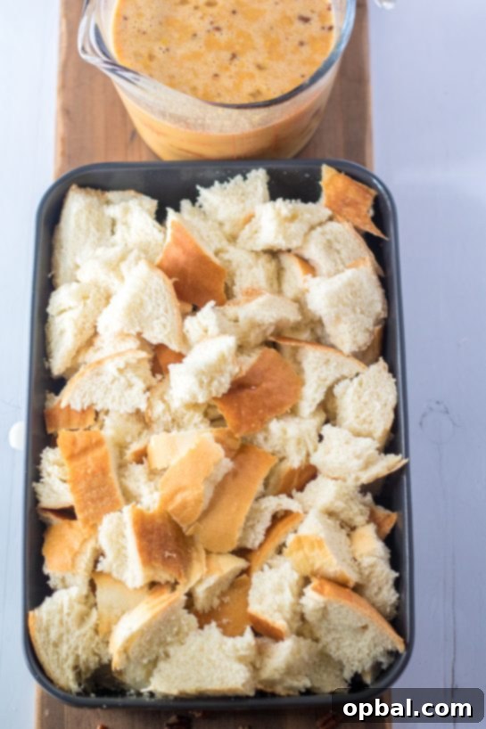 Spiced Sweet Potato French Toast Bake 5 Cubed challah bread, torn into bite-sized pieces and spread evenly in a baking dish, forming the delicious base for the Sweet Potato French Toast Casserole recipe.