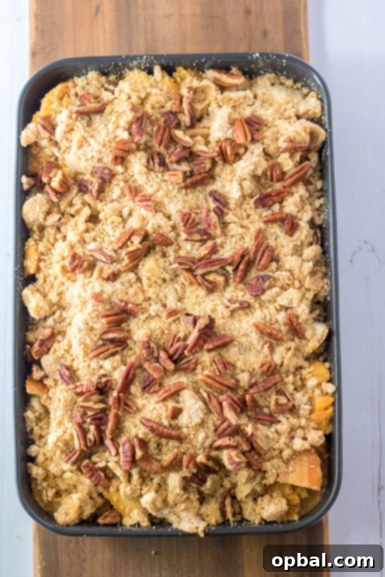 Spiced Sweet Potato French Toast Bake 8 The Sweet Potato French Toast Casserole, covered with a delightful pecan streusel topping, is perfectly prepped and ready to be placed into the oven.