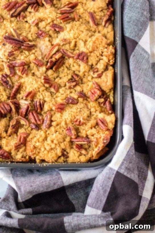 Spiced Sweet Potato French Toast Bake 9 A freshly baked Sweet Potato French Toast Casserole, with a golden-brown, crispy pecan topping, just pulled from the oven and emitting a warm, inviting aroma.