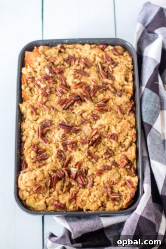 Spiced Sweet Potato French Toast Bake 10 The full Sweet Potato French Toast Casserole, baked to perfection with a delightful crunchy topping, displayed in its baking dish and ready to be portioned and served for Thanksgiving dinner or breakfast.