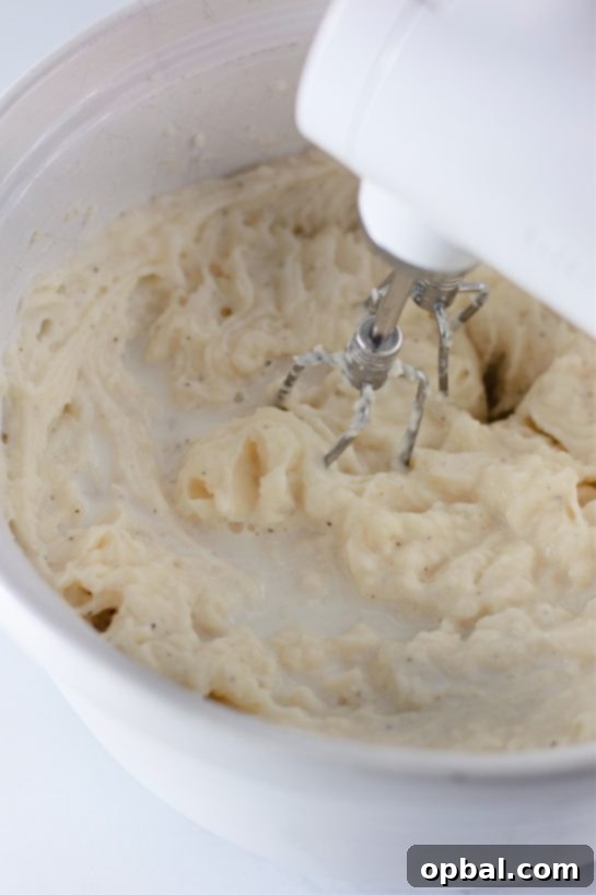 Amish Country Mashed Potatoes 7 Mashing the potatoes for the Country creamy Amish Mashed Potatoes Recipe