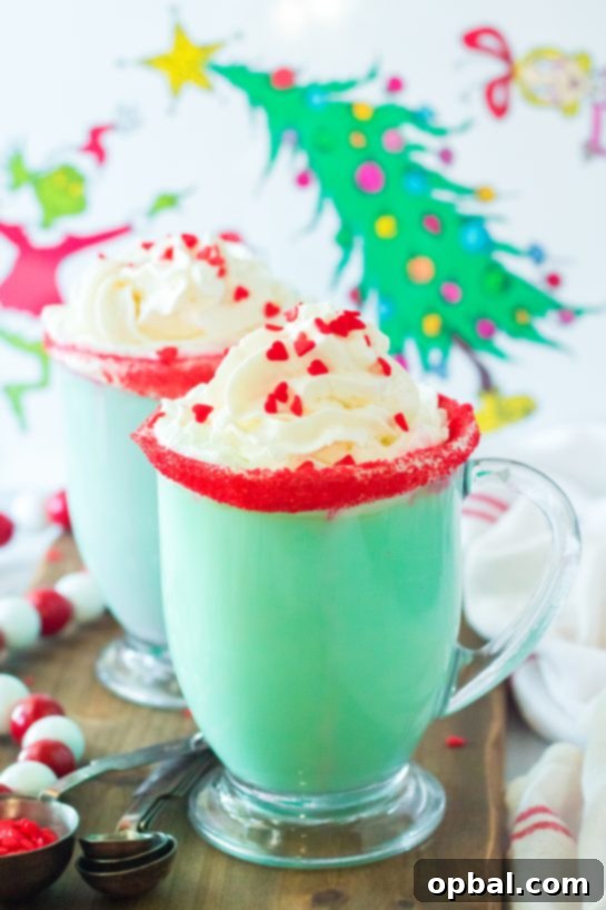Grinchy Christmas Delight 10 Vibrant green Grinch Hot Chocolate ready to be served, topped with whipped cream and red sprinkles.