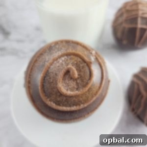 Close-up of a finished Mocha Hot Chocolate Bomb with a drizzle of white chocolate.