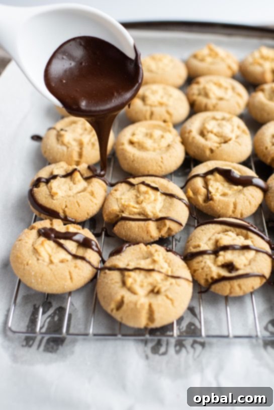 Peanut Butter Pressed Delights 12 Drizzling the chocolate ganache for the Peanut Butter Thumbprint Cookies recipe