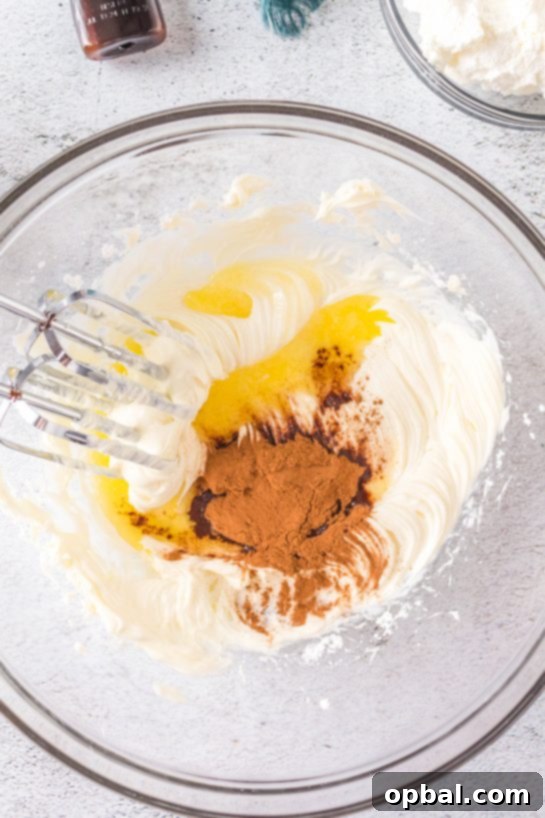 Frosted Cinnamon Roll Dip 5 Ingredients being mixed to make this easy Cinnamon Roll Dip recipe