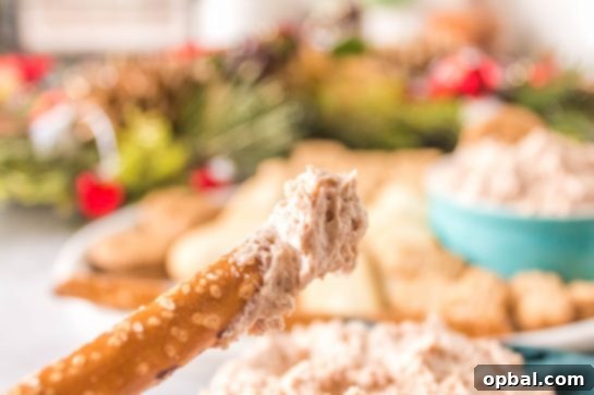 Frosted Cinnamon Roll Dip 6 Dipping pretzels in the Cinnamon Roll Dip recipe for Christmas or holiday dessert