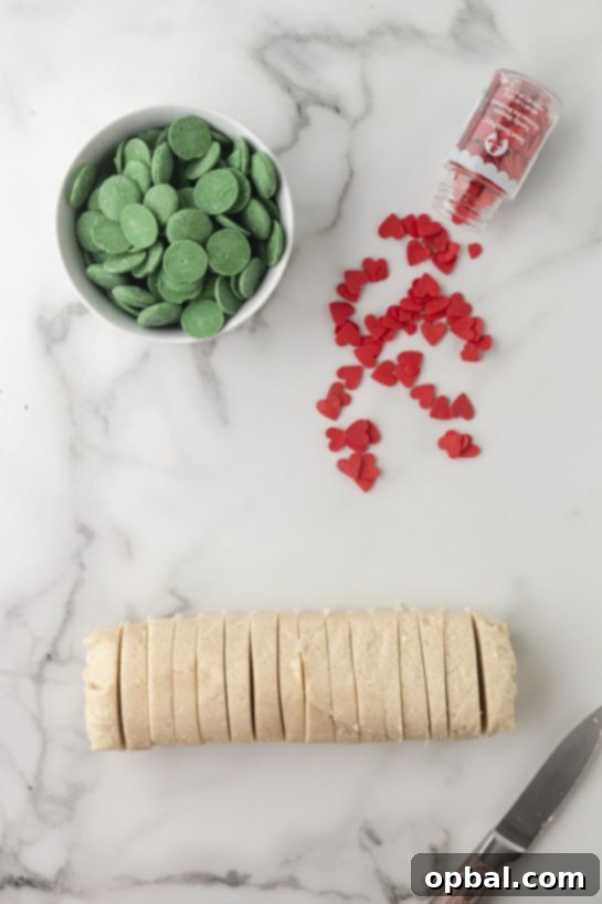 Grinchy Holiday Cookie Cups 3 Slicing the dough for the Grinch Cookie Cup Bites recipe