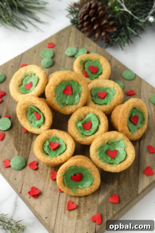 Grinchy Holiday Cookie Cups 6 Easy Grinch Cookie Cup Bites recipe is inspired by Dr. Seuss’s How the Grinch Stole Christmas! They are chewy sugar cookies that have been colored green and adorned with a red heart for a fun holiday dessert!