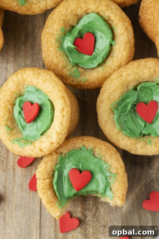 Grinchy Holiday Cookie Cups 10 Dr. Suess' the Grinch Cookie Cup Bites recipe is inspired by Dr. Seuss’s How the Grinch Stole Christmas! They are chewy sugar cookies that have been colored green and adorned with a red heart for a fun holiday dessert!