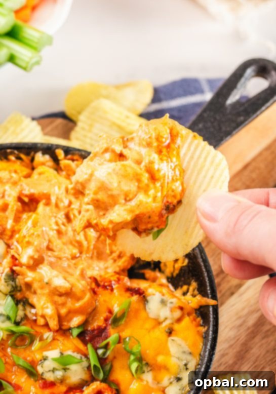 Ultimate Game Day Buffalo Chicken Dip 3 Close-up of bubbling Buffalo Chicken Wing Dip with melted cheese and rich, creamy texture.