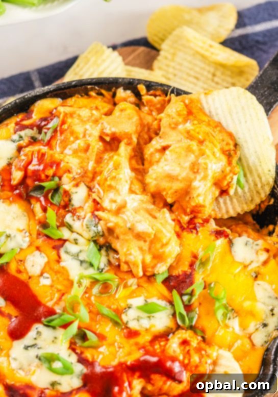 Ultimate Game Day Buffalo Chicken Dip 8 Buffalo Chicken Wing Dip served alongside a variety of chips and vegetables for dipping.