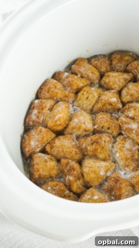 Crockpot Pull-Apart Perfection 8 The glaze covering the biscuits in the slow cooker to make the Crock Pot Monkey Bread recipe