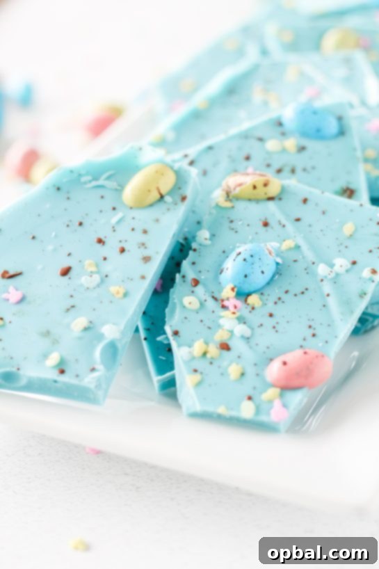 Speckled Robin's Egg Easter Bark 7 Close-up of the finished No-Bake Robin Egg Easter Bark, showcasing its beautiful blue hue and candy egg toppings.