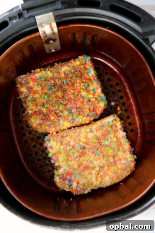 Crispy Air Fryer Fruity Pebble French Toast 6 Putting the prepared bread in the air fryer for the Air Fryer Fruity Pebble French Toast recipe