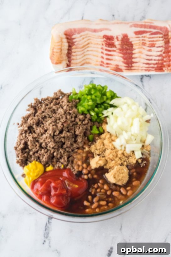 Hearty Beef & Bean Bake 5 Mixing the ingredients needed to make the beefy baked beans side dish recipe