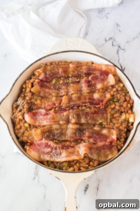 Hearty Beef & Bean Bake 6 Placing the cooked bacon on top of the pot to make the beefy baked beans side dish recipe