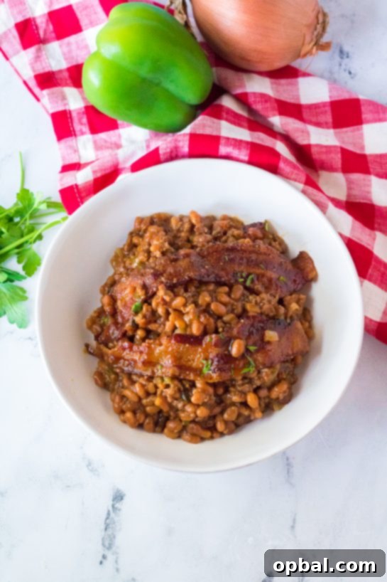 Hearty Beef & Bean Bake 7 Beefy Baked Beans are my favorite for a BBQ or picnic! Beans get mixed with ground beef, onion and bell pepper, brown sugar, ketchup, mustard and Worcestershire before getting topped with a crispy, peppered brown sugar bacon.