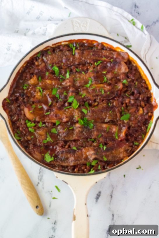 Hearty Beef & Bean Bake 9 Easy Beefy Baked Beans are my favorite side dish recipe! Beans get mixed with ground beef, onion and bell pepper, brown sugar, ketchup, mustard and Worcestershire before getting topped with a peppered brown sugar bacon.