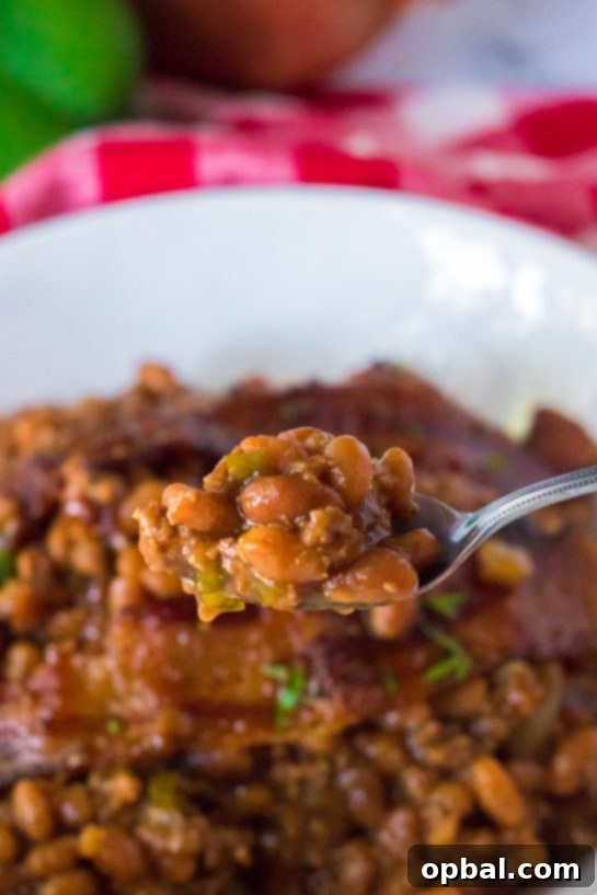 Hearty Beef & Bean Bake 10 Easy Beefy Baked Beans are my favorite side dish recipe for summer cook-outs! Beans get mixed with ground beef, onion and bell pepper, brown sugar, ketchup, mustard and Worcestershire before getting topped with a peppered brown sugar bacon.