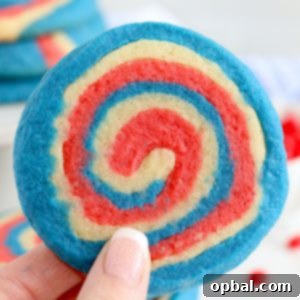 Patriotic Pinwheel Cookies are a classic, slice and bake soft sugar cookie recipe all dressed up for the 4th of July! These patriotic pinwheel cookies have beautiful swirls of red, white and blue.