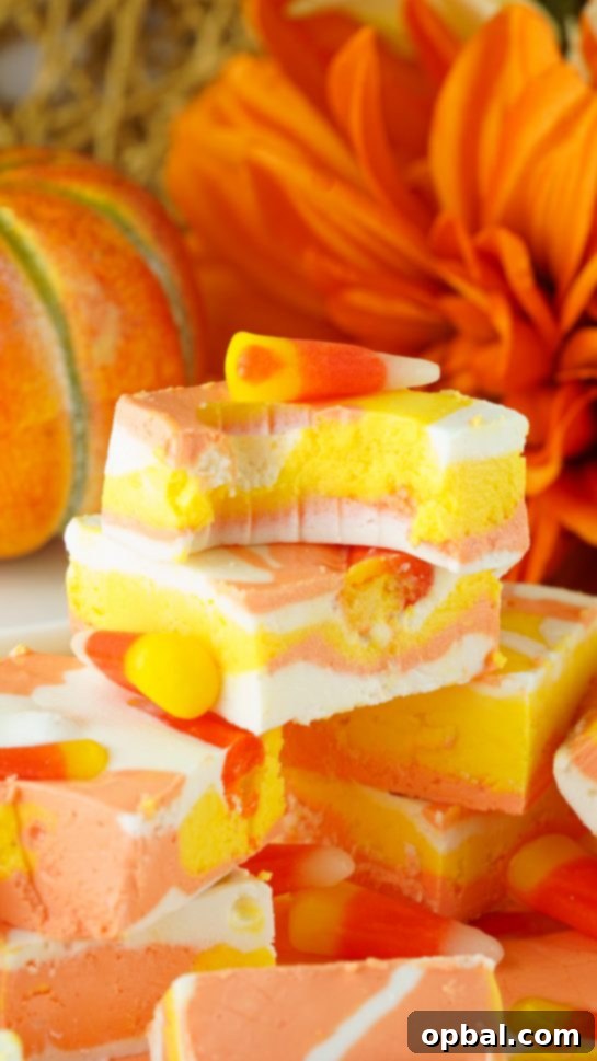 Tri-Color Candy Corn Fudge 9 Close-up of the finished No-Bake Candy Corn Fudge, showcasing its vibrant layers and candy corn topping, a perfect Halloween treat.