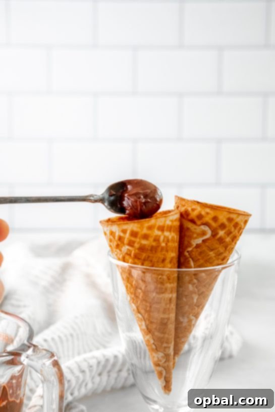 Cannoli Crunch Ice Cream Cones 5 Scooping in the melted chocolate needed to make the Ice Cream Cannoli Cones recipe