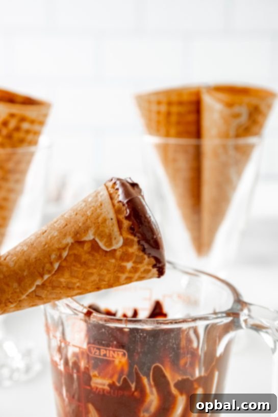 Cannoli Crunch Ice Cream Cones 6 Dipping the cones in the melted chocolate to make the Ice Cream Cannoli Cones recipe