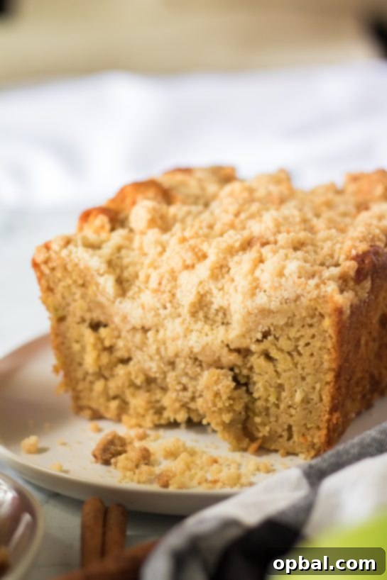 Homestyle Apple Crumble Coffee Cake 7 A full Apple Streusel Coffee Cake presented on a rustic wooden board, ready for serving.