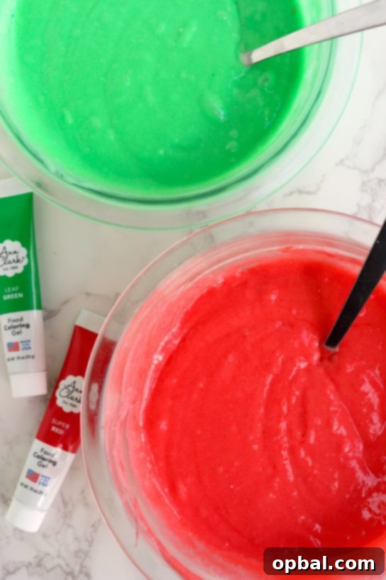 Festive Yule Log Cake 4 Mixing vibrant red and green gel food coloring into separate cake batters for a festive Christmas Cake Roll.