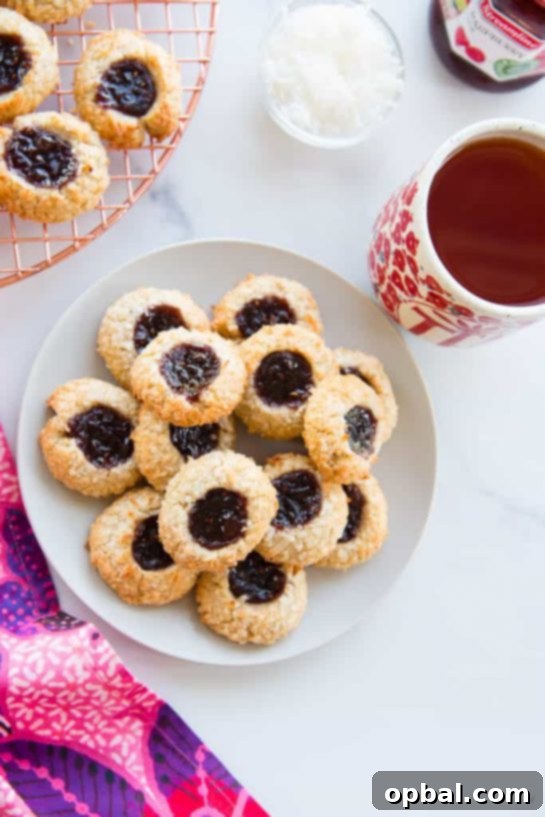 Signature Thumbprint Treats 8 Tropical Coconut Raspberry Thumbprint Cookies, a delightful combination of sweet coconut and tart raspberry jam.