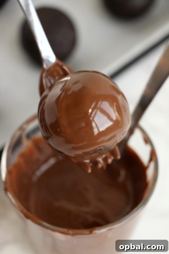 Gobble-Worthy Cake Pops 7 Dipping the cake balls in the melted chocolate for the Easy Turkey Cake Pops recipe