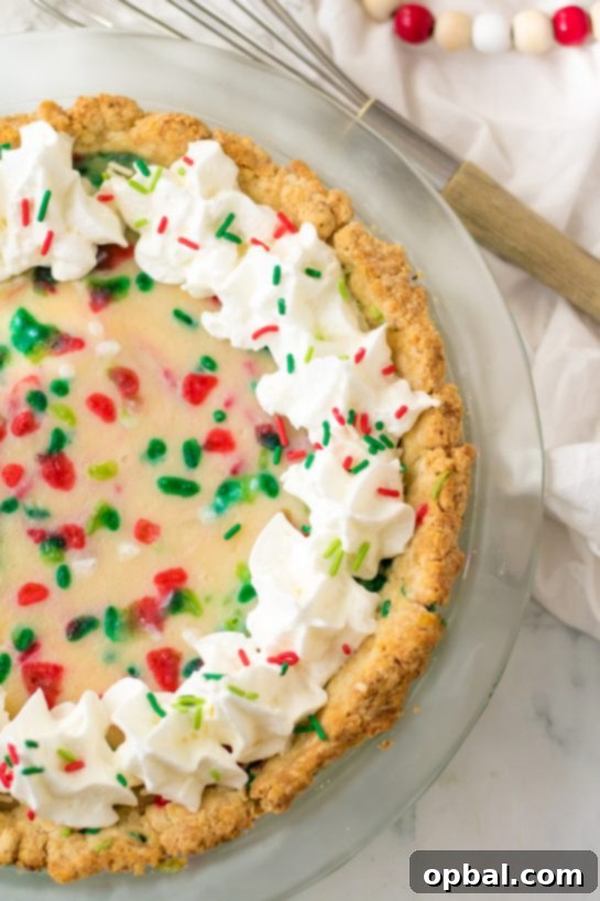 Velvet Sugar Pie 10 A tantalizing close-up shot of a slice of Christmas Sugar Cream Pie, showcasing its smooth texture and delightful sprinkles.