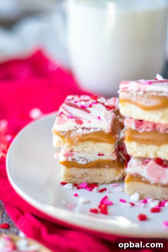 Sweet Valentine's Millionaire Bars 12 A stack of beautifully cut Valentine's Day Millionaire Bars, showcasing their intricate layers and irresistible appeal, ready to be enjoyed.