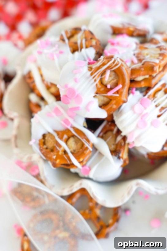 Sweetheart Pretzel Bites 2 Valentine's Day Pretzel Bites: Peanut butter-filled pretzels dipped in white chocolate with festive sprinkles, perfect for gifting and parties.