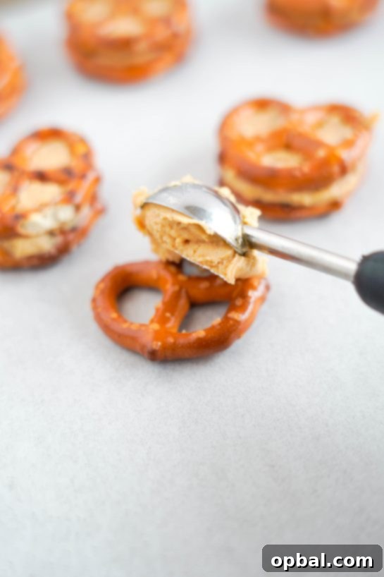 Sweetheart Pretzel Bites 4 Scooping creamy peanut butter onto pretzel twists for Valentine's Day Pretzel Bites.