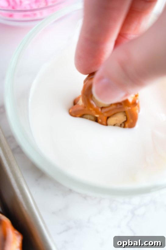 Sweetheart Pretzel Bites 6 Dipping peanut butter pretzel bites into melted white chocolate for a smooth coating.