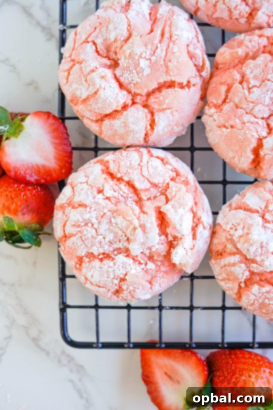 Luscious Strawberry Crinkles 7 A close-up view of a baked Strawberry Crinkle Cookie, showcasing its perfect crinkled texture and delicious strawberry flavor.