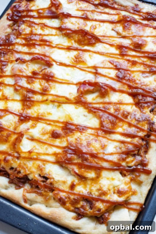 A delicious Sheet Pan BBQ Chicken Pizza with crispy crust, melting cheese, and tender chicken.