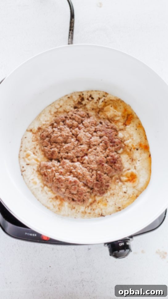 Viral Big Mac Tacos 3 Browning ground beef in a skillet for the Big Mac Tacos recipe, preparing the savory base for a low-carb Big Mac experience.