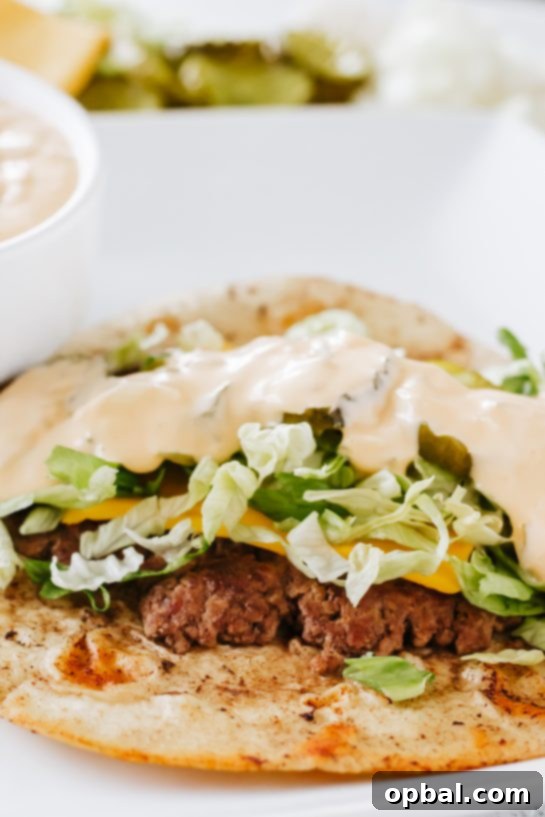 Viral Big Mac Tacos 8 A close-up shot of a Big Mac Taco, highlighting the melted cheese, crisp lettuce, and abundant special sauce on a savory tortilla base.