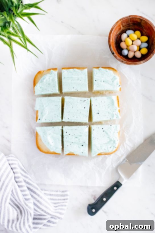 Robin's Egg Easter Cakelets 8 A slice of the frosted and speckled Easter Snack Cake being cut, revealing the fluffy white interior.