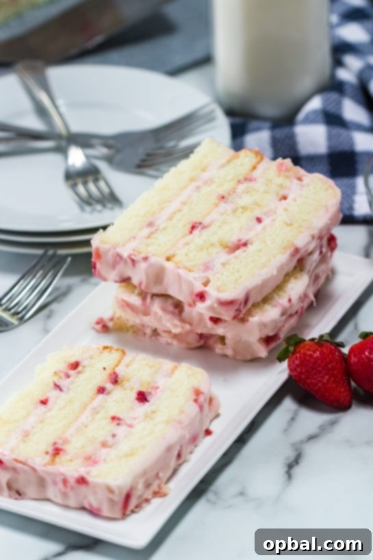 Strawberry Cloud Layer Cake 8 A beautifully sliced Strawberries & Cream Layered Cake, revealing its delicate layers and ready to be served for Easter dessert or any special occasion.