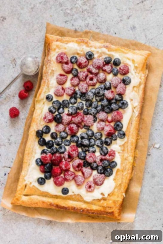 22 Firecracker Flavors for the Fourth 21 Easy Berry Tart recipe with puff pastry, yogurt, and fresh berries, perfect for a 4th of July brunch or any summer gathering.