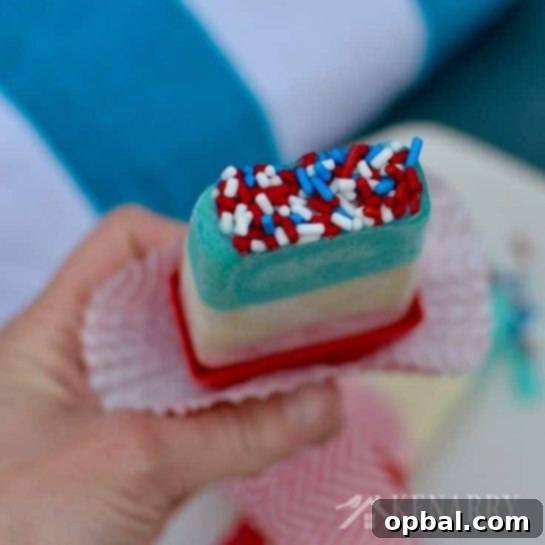22 Firecracker Flavors for the Fourth 6 Easy and delicious Patriotic Pudding Pops, featuring vibrant red, white, and blue layers, a favorite cooling treat for the 4th of July.