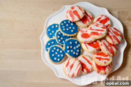 22 Firecracker Flavors for the Fourth 8 Fun Cookie Flag cut-out cookies recipe for the 4th of July, perfect for kids to decorate with red, white, and blue frosting and sprinkles.